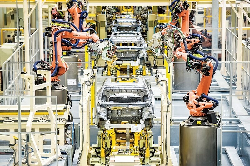 發(fā)展新能源汽車是我國從汽車大國邁向汽車強(qiáng)國的必由之路。2022年中國新能源汽車產(chǎn)銷分別實(shí)現(xiàn)705.8萬輛和688.7萬輛，連續(xù)8年位居世界第一。圖為廣汽埃安第一智造中心焊裝車間正在熱火朝天地生產(chǎn)。 廣汽埃安新能源汽車股份有限公司供圖