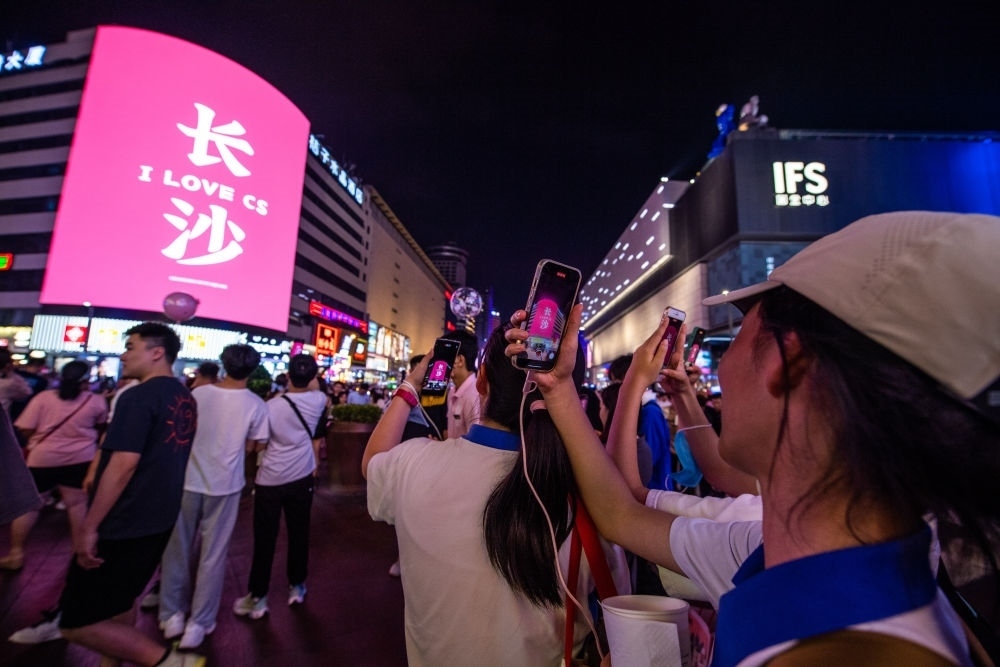  游客在長(zhǎng)沙市天心區(qū)黃興路步行街打卡、拍照（6月7日攝）。新華社記者 陳思汗 攝