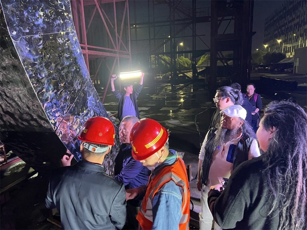 林崗（右二）和團(tuán)隊(duì)查看主火炬制作進(jìn)度。受訪者供圖