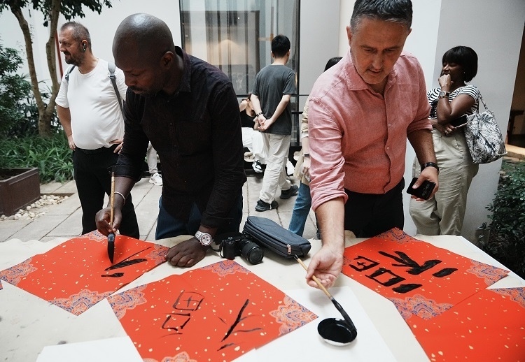 首屆國際傳播“絲路獎”獲獎代表等在廣州市荔灣區(qū)永慶坊參加文化交流活動。楊爍壁、王燕攝影報道