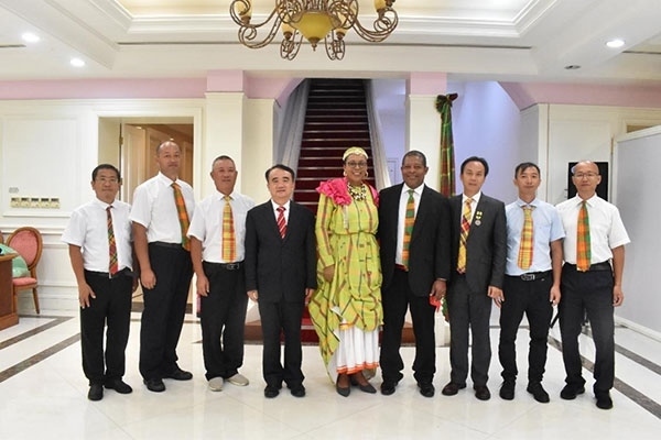 多米尼克總統(tǒng)伯頓和駐多米尼克大使林先江與中國(guó)農(nóng)業(yè)技術(shù)專(zhuān)家組合影。中國(guó)駐多米尼克大使館供圖