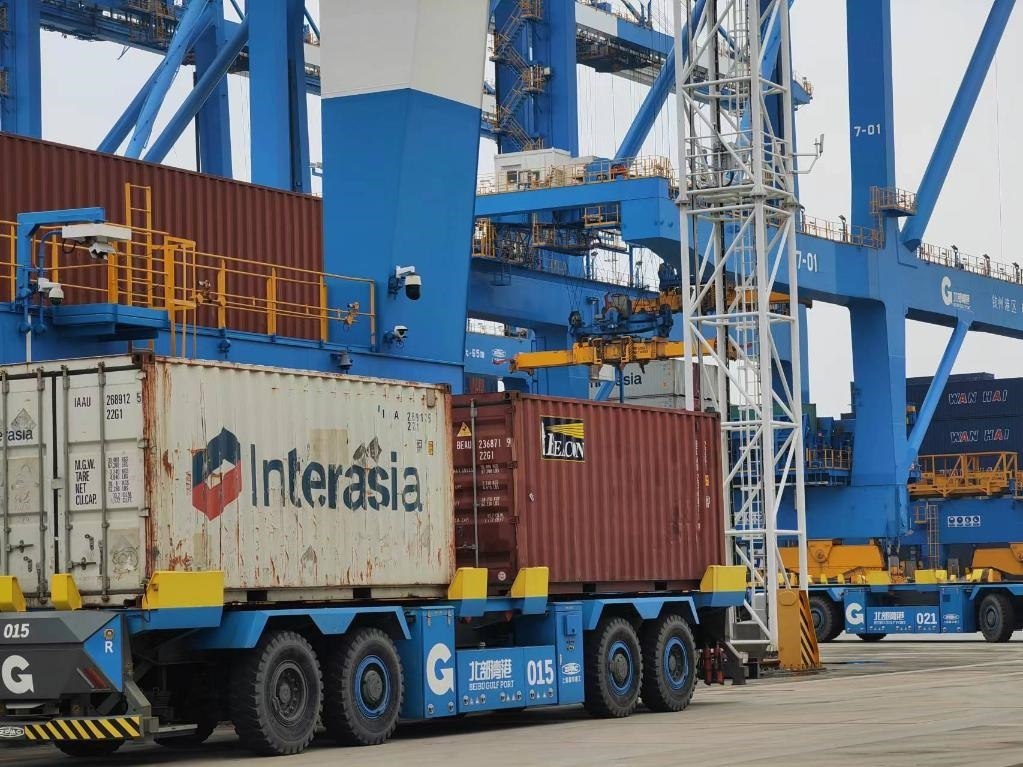 在欽州自動化集裝箱碼頭，智能導(dǎo)引運(yùn)輸車在運(yùn)送集裝箱。新華社記者趙歡 攝