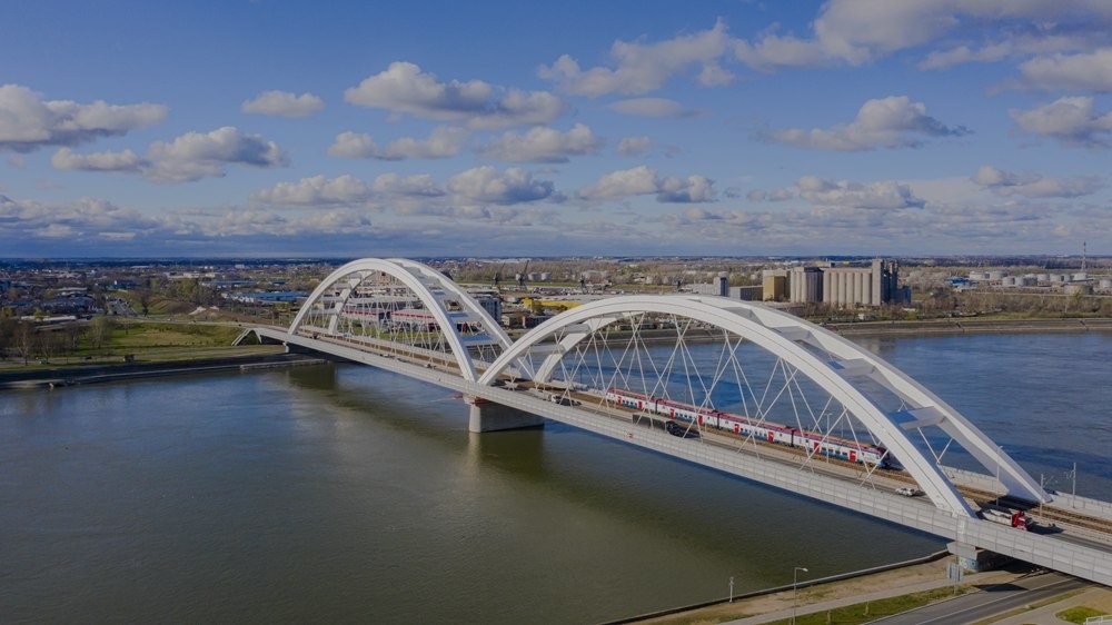 2024年3月12日，一列火車運(yùn)行在匈塞鐵路塞爾維亞境內(nèi)貝諾段諾維薩德多瑙河大橋上（無人機(jī)照片）。新華社發(fā)（任衛(wèi)云攝）