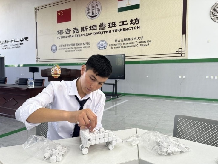 在塔吉克斯坦魯班工坊內(nèi)，學(xué)員正在操作能力源創(chuàng)新套件。本報(bào)記者 屈佩 攝