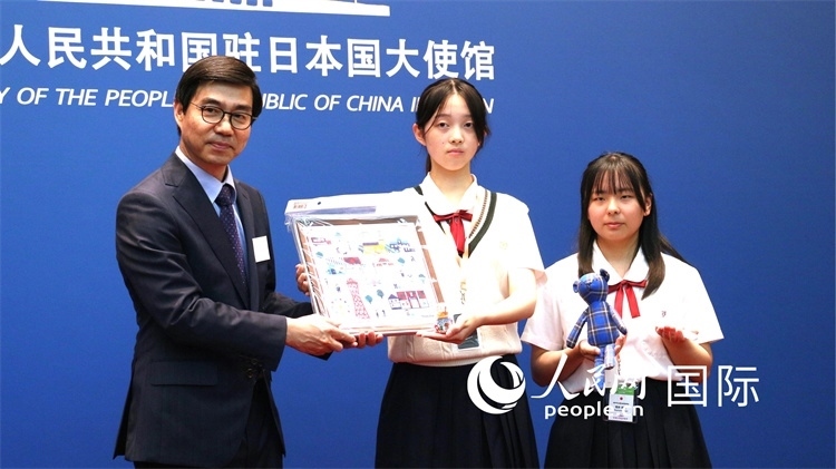 日本小大使向中國駐日本大使館臨時(shí)代辦施泳贈(zèng)送當(dāng)?shù)靥厣Y品。人民網(wǎng) 許可攝