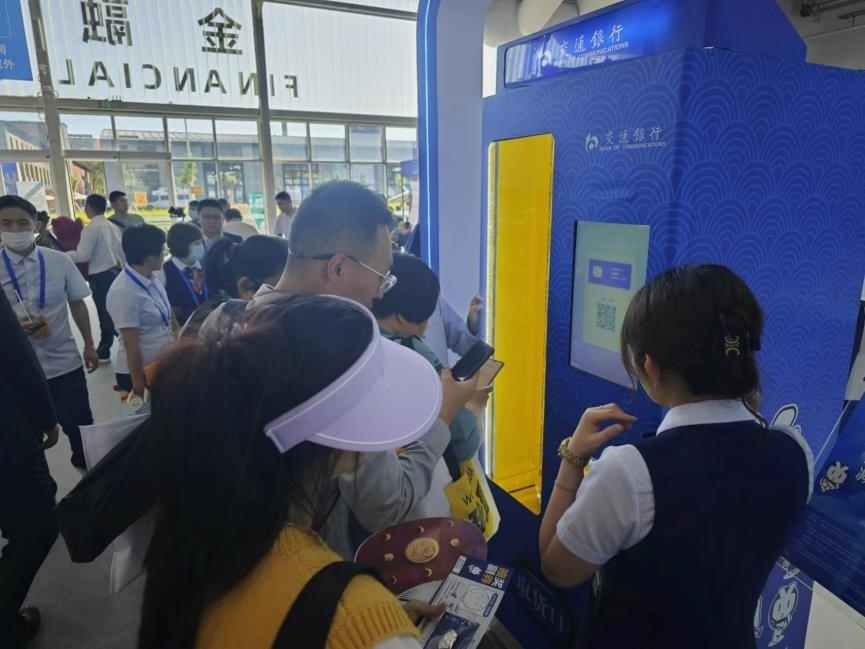 觀眾在金融服務(wù)展區(qū)體驗數(shù)字人民幣購物。人民網(wǎng)記者 黃盛攝