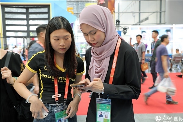 東博會(huì)現(xiàn)場(chǎng)，馬來西亞展商在同中方工作人員交談。人民網(wǎng)記者 趙益普攝