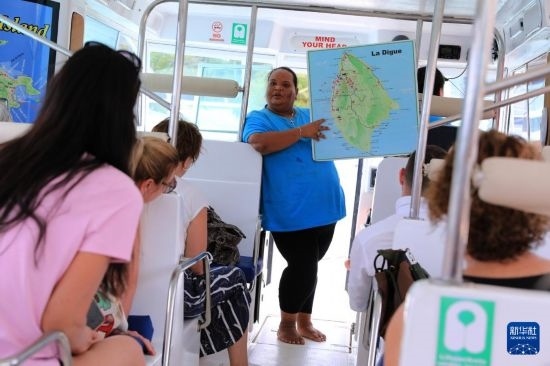 3月15日，一名導游在游艇上為游客介紹塞舌爾拉迪格島。新華社記者 董江輝 攝