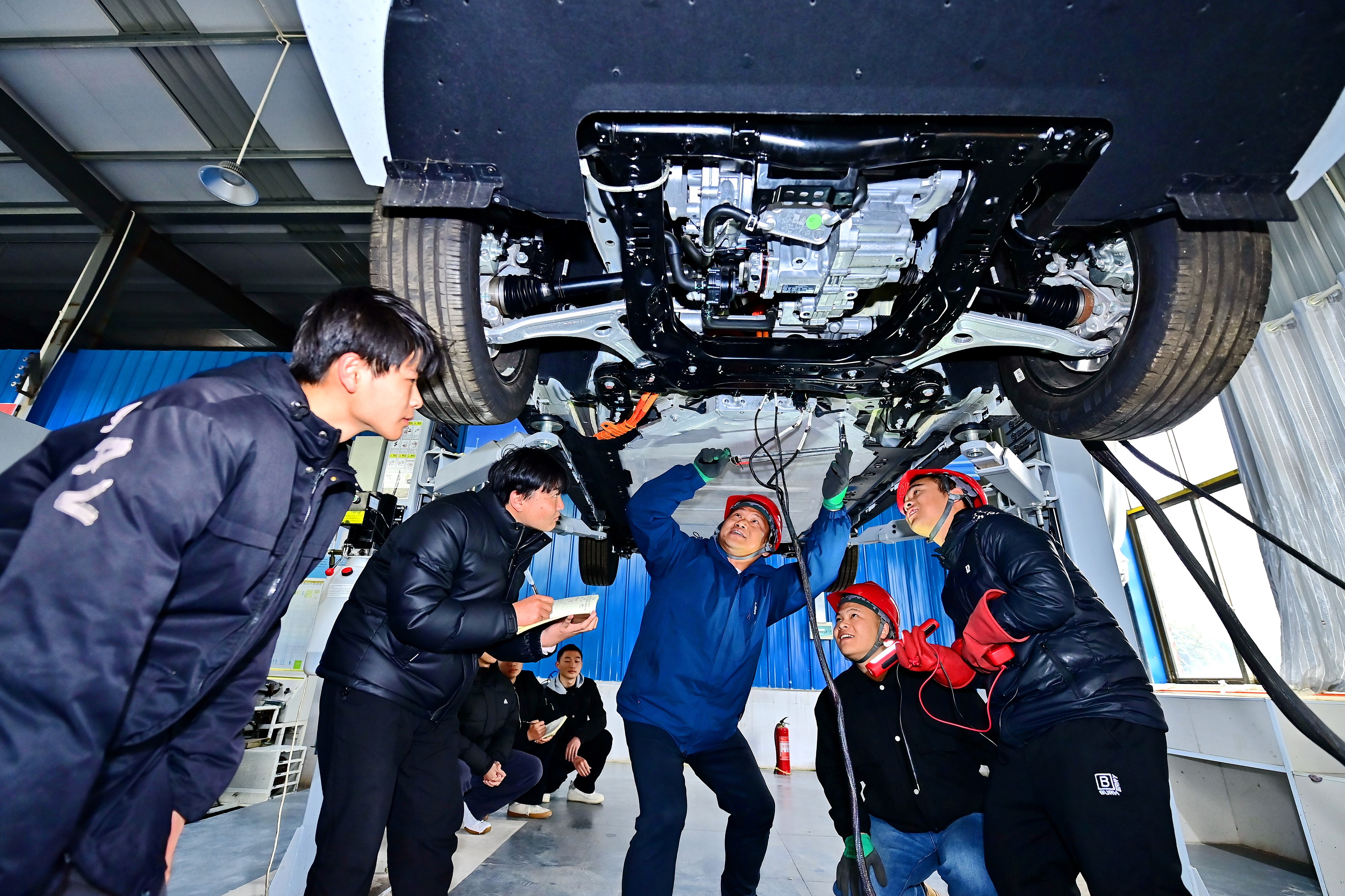 2025年2月，江西省宜春市，豐城市的一所技工學(xué)校實訓(xùn)基地內(nèi)，新能源汽車運(yùn)維專業(yè)學(xué)生在老師的指導(dǎo)下學(xué)習(xí)新能源汽車電池包檢修技術(shù)。